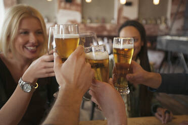 Friends toasting with beer in cafe - BLEF14030