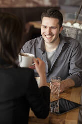 Couple drinking coffee in cafe - BLEF14045