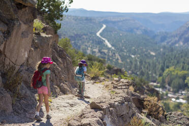 Children hiking together on rocky mountainside - BLEF14098