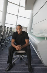 Smiling Black businessman sitting in conference room - BLEF14167