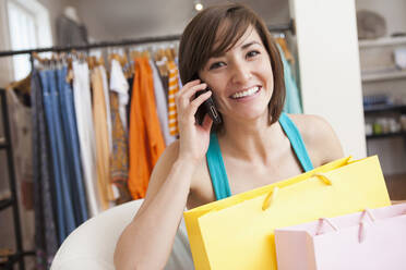 Hispanic woman shopping in clothing store - BLEF14181