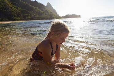 Caucasian girl playing in ocean - BLEF14186