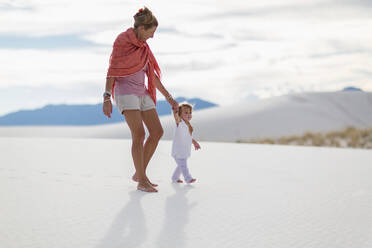 Caucasian mother and son walking on sand dune - BLEF14205