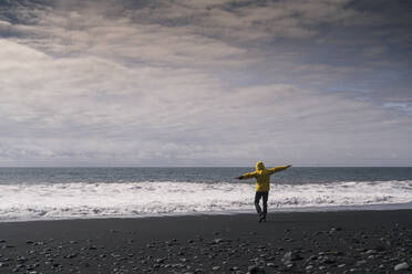 Mature man on a lava beach in Iceland, rear view - UUF18670
