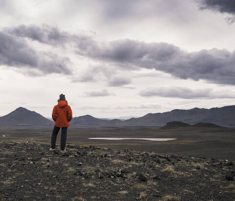 Young woman looking at view, Highland region, Iceland stock photo