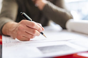 Close-up of architect working on plan in office - DIGF07917