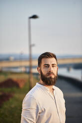 Portrait of a man with beard at a riveriside - ZEDF02541