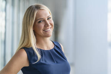 Portrait of smiling blond businesswoman in summer - DIGF08040