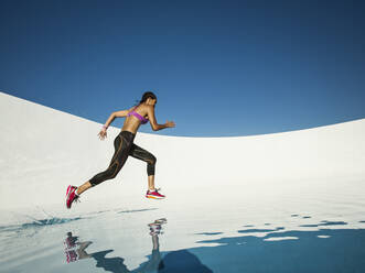 Mixed race woman running on water surface - BLEF14281