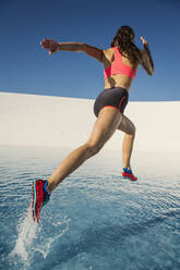 Caucasian woman running on water surface - BLEF14285