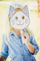 Kaukasisches Mädchen hält Katzenmaske - BLEF14312