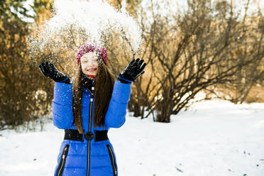 Caucasian girl throwing snow field - BLEF14369