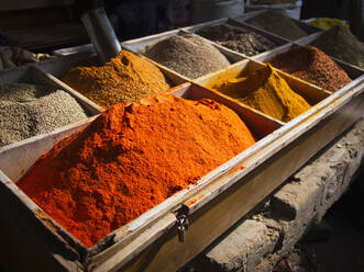 Bins of dried spices for sale in market - BLEF14395