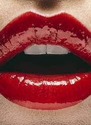 Close up of mouth of woman wearing red lipstick - BLEF14410