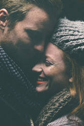 Smiling couple wearing warm clothing hugging - BLEF14413