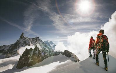 Caucasian hikers standing on snowy mountain top, Mont Blanc, Alps, France - BLEF14540