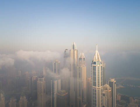 Aerial view of skyscrapers touching the clouds in Dubai, United Arab Emirates. stock photo
