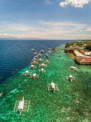 Aerial view of resort, coral reef and filipino boats, Moalboal, Philippines. - AAEF01814