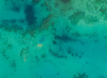 Aerial view of one boat in turquoise waters near Tagbilaran city, Philippines. - AAEF01823
