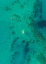 Aerial view of one boat in turquoise waters near Tagbilaran city, Philippines. - AAEF01824