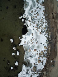 Aerial view of snowy rocky beach in Estonia. - AAEF02141