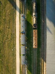 Aerial view of a railway with trains in countryside of Estonia. - AAEF02155