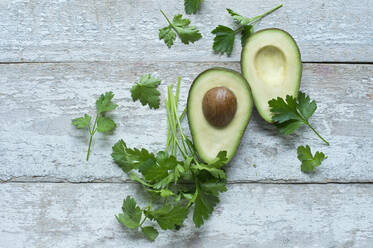 Directly above shot of avocados with parsley on wooden table - ASF06490