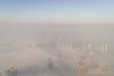 Aerial view of misty skyscrapers in Business Bay, Dubai, UAE. - AAEF02260