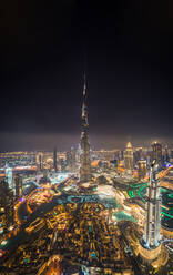 Aerial view of Burj Khalifa Tower and skyscrapers at night in Dubai, UAE. - AAEF02279