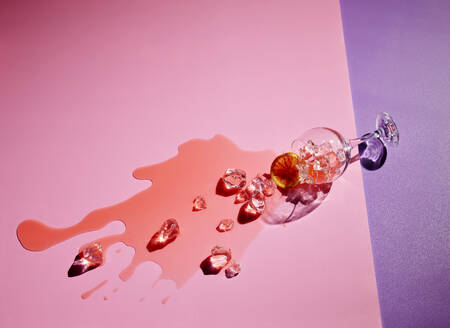 High angle view of drink fallen on colored background - KSWF02041