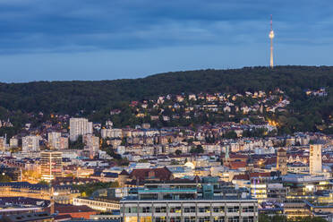 Exterior of illuminated buildings and communications tower against sky at dusk in Stuttgart, Germany - WDF05398