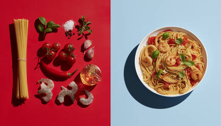 Directly above shot of shrimp pasta by ingredients on colored background - KSWF02055