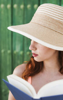 Young woman with book in summer - LJF00674