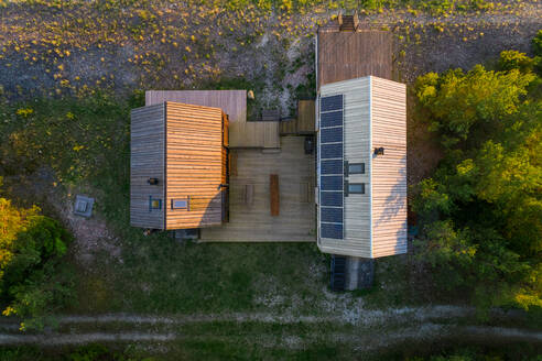 Aerial view of an isolated houses in the edge of a forest in Forby on Vormsi island, Estonia. - AAEF02541