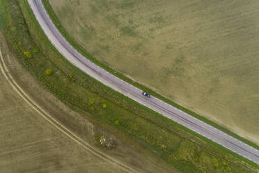 Aerial view road going through field in Estonia. - AAEF02656