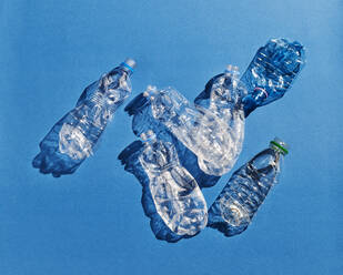 Plastic bottles on blue background - KSWF02080