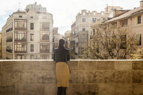 Woman looking at Placa dels Furs, Fueros Museum from Torres de Serranos, Valencia, Spain stock photo