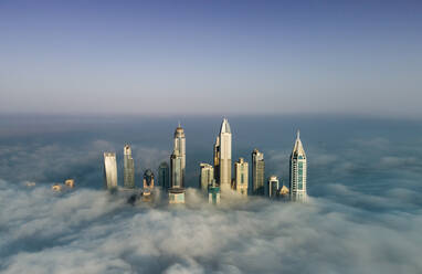 Aerial view of skyscrapers in the clouds of Dubai, U.A.E. - AAEF02759