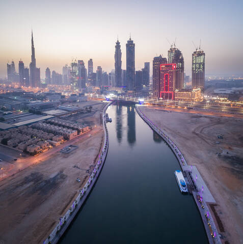 Aerial view of canal and illuminated skyscrapers in downtown Dubai at night, U.A.E. stock photo