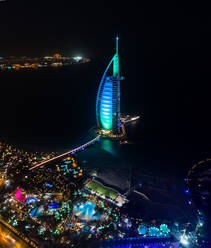 Aerial view of the luxurious Burj Al Arab Hotel by night in Dubai bay, U.A.E. - AAEF02792