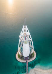 Aerial view of the luxurious Burj Al Arab Hotel on a sunny day in Dubai bay, U.A.E. - AAEF02793
