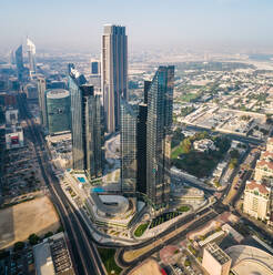 Aerial view of a skyscraper in the shadow of Burj Khalifa Tower in Dubai, U.A.E. - AAEF02814