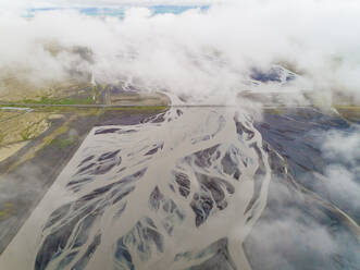 Aerial view of road crossing a glacial river on the southern region of Iceland. - AAEF02946