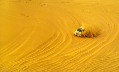Desert safari adventure in 4x4 vehicle bashing side to side through the desert dunes at sunset in Qatar and Saudi Arabia, Qatar, Middle East - RHPLF00624
