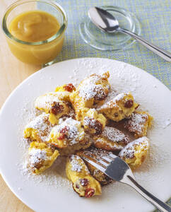 Kaiserschmarrn with raisins and apple sauce in plate on table - PPXF00248