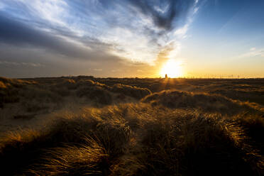 Sunset over the dunes and the Parish Church of the Holy Trinity and All Saints at Winterton on Sea, Norfolk, England, United Kingdom, Europe - RHPLF01007