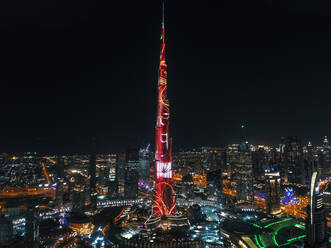 Aerial view of illuminated Burj Khalifa Tower at night in Dubai, United Arab Emirates. - AAEF03240