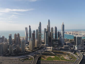 Aerial view of skyscrapers and sea in the background in Dubai, United Arab Emirates. - AAEF03242