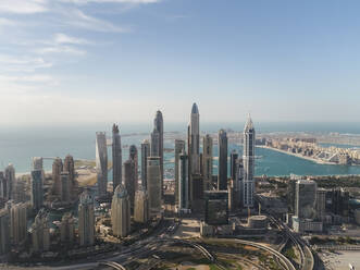 Aerial view of skyscrapers and sea in the background in Dubai, United Arab Emirates. - AAEF03244