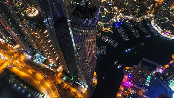 Aerial view of illuminated skyscrapers at night in Dubai, United Arab Emirates. - AAEF03257